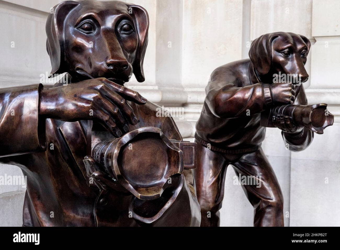 Paparazzi Dogs; bronze sculptures by New York based artistic duo Gillie and Marc on public display at the entrance to The Royal Exchange, London, UK. Stock Photo