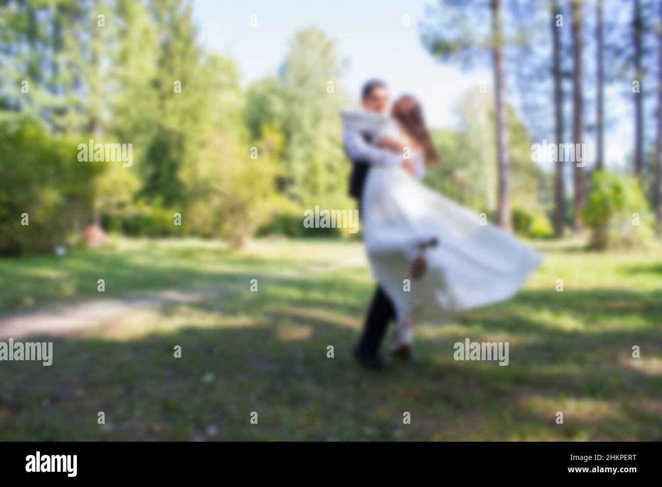 Bride and groom on nature background. Blurred Stock Photo - Alamy