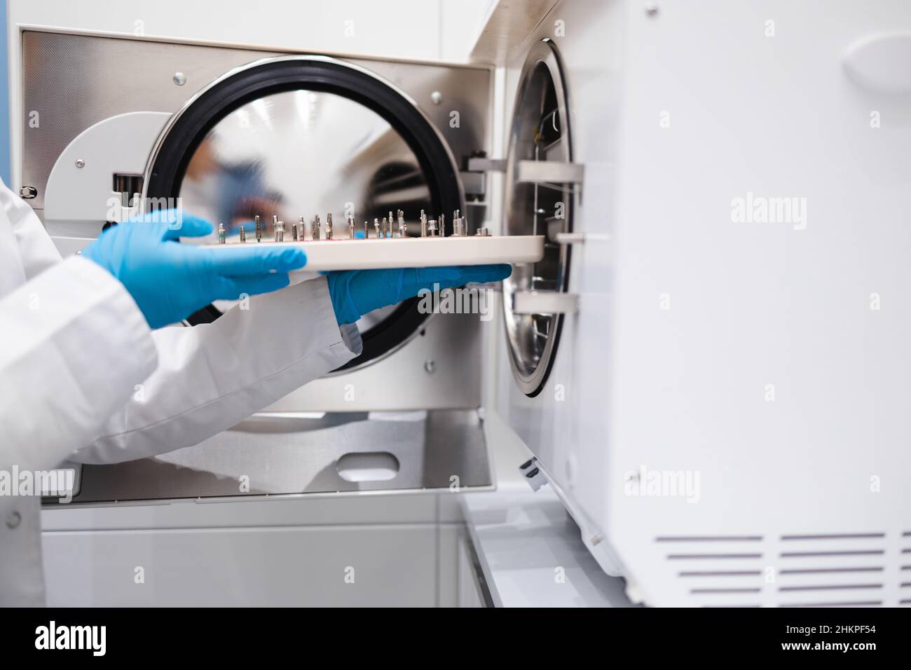 Closeup view of the hands of female dentistry worker who puts a dental