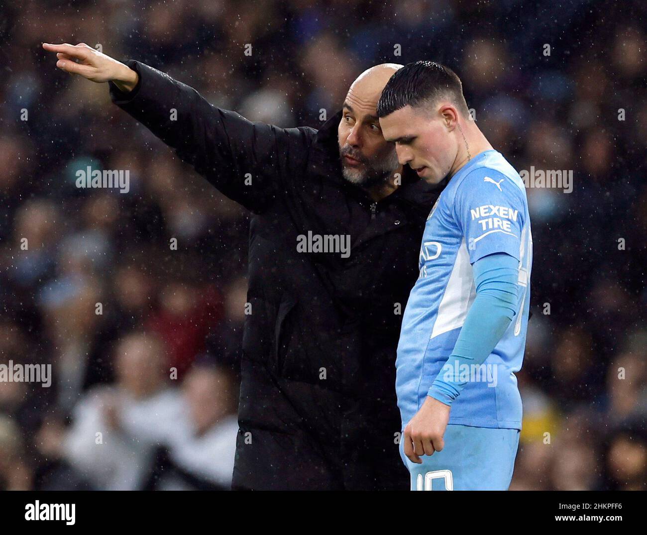 Soccer Football - FA Cup - Fourth Round - Manchester City v Fulham - Etihad Stadium, Manchester, Britain - February 5, 2022 Manchester City manager Pep Guardiola speaks with Phil Foden Action Images via Reuters/Jason Cairnduff Stock Photo
