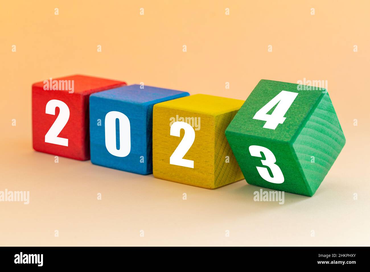 2023 To 2024 White Numbers On Joyfully Colored Blocks Merry Christmas And A Happy New Year Apricot Background 2HKPHXY 