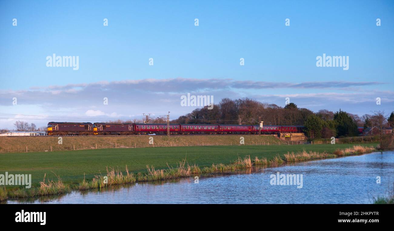 2 West Coast Railways class 33 diesel locomotives on the west coast mainline with a train of empty MK1 carriages passing Catterall, Lancashire. Stock Photo