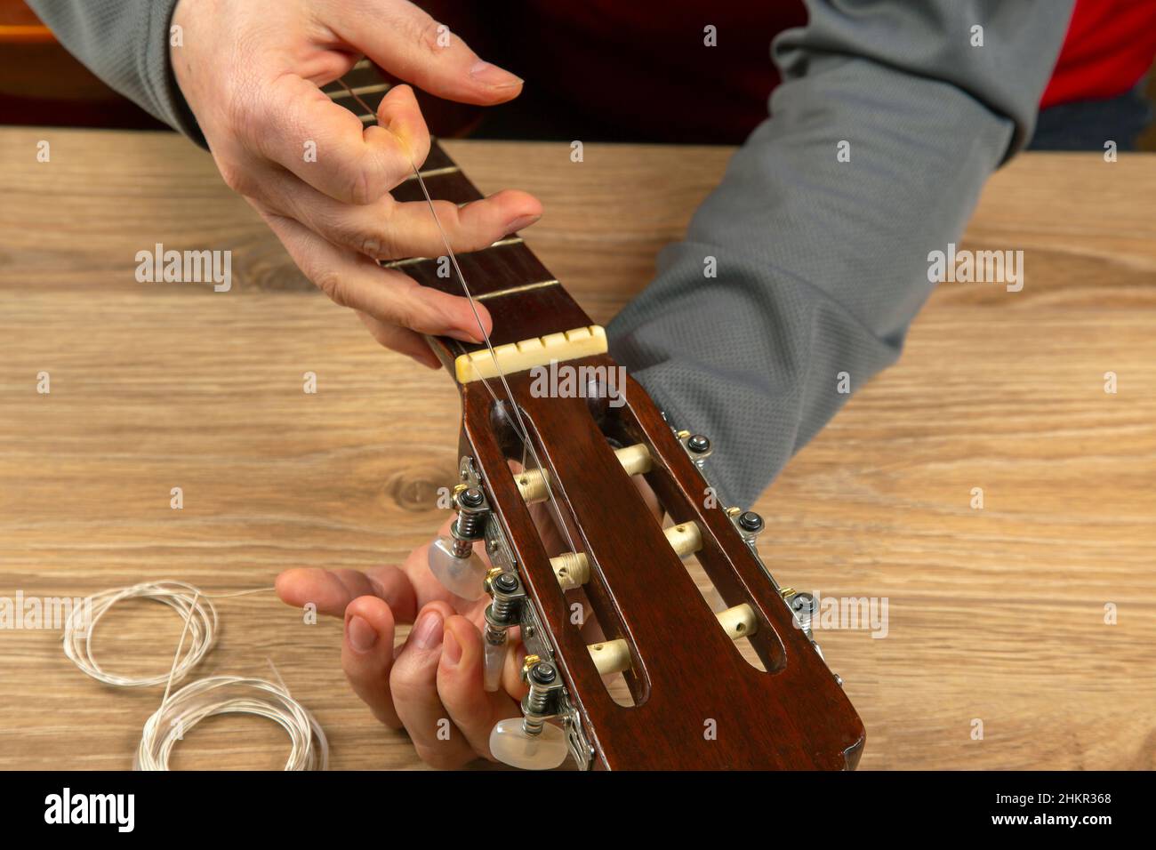 Changing nylon strings on a sixstring classical guitar. instruction