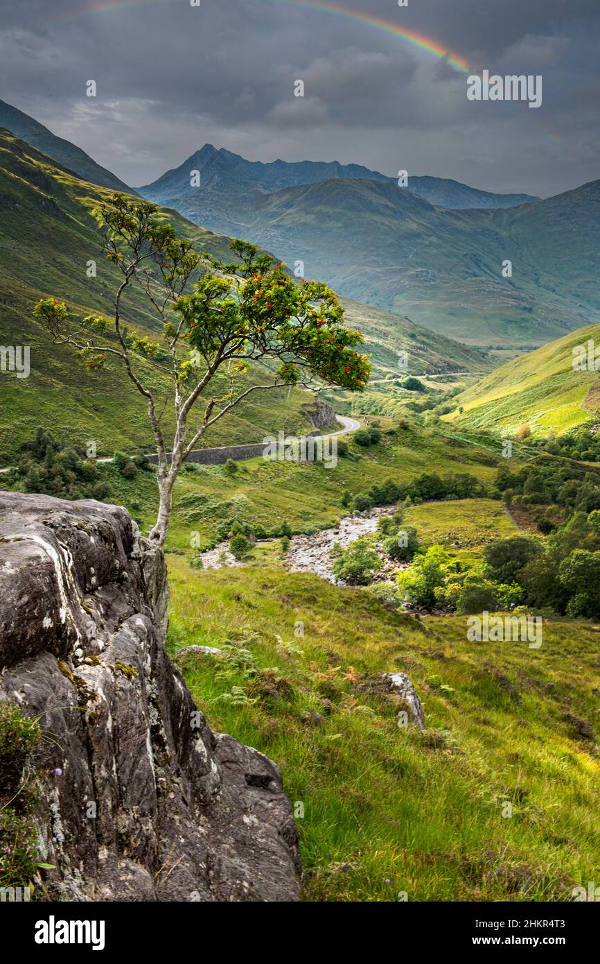 A rainbow over a valley in the Highlands of Scotland Stock Photo