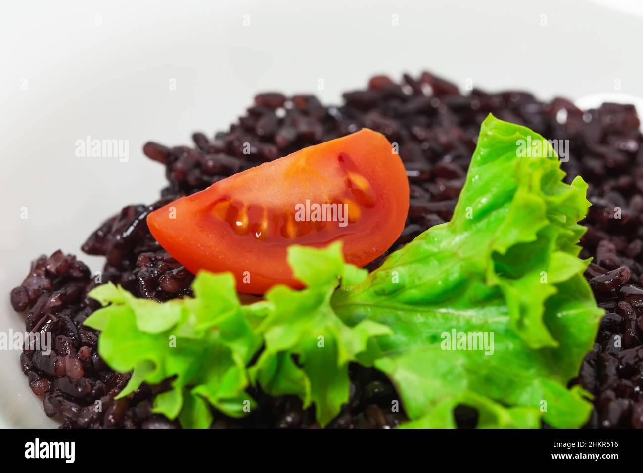 Black rice risotto with tomato. As a whole background Stock Photo Alamy