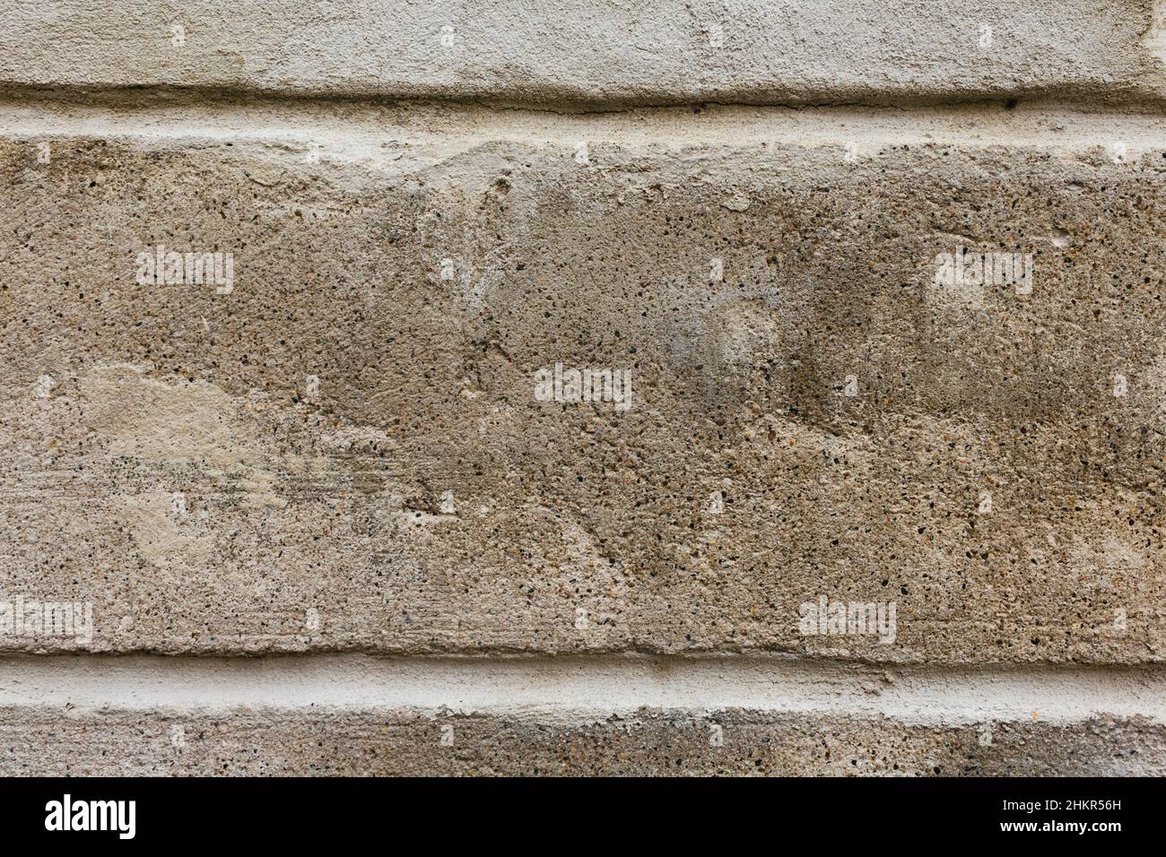 detail of a plastered light brown wall with two horizontal joints. Renovation would be necessary. Pattern for grunge background. Stock Photo