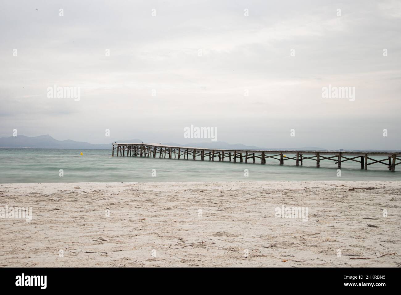 Wood pier during a cloudy day in Mallorca, Spain Stock Photo