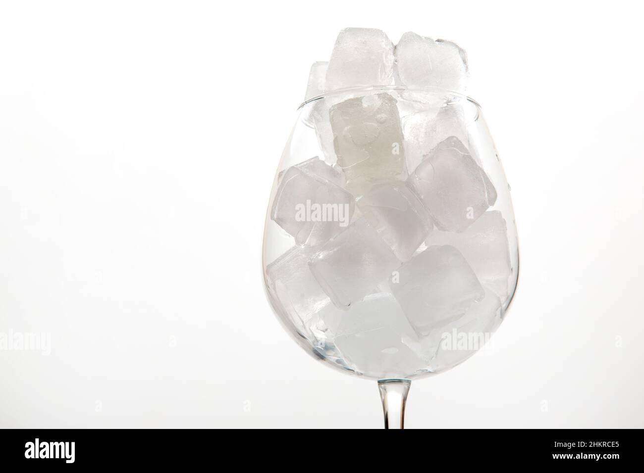 frozen ice cubes in an empty wine glass on a light background Stock Photo Alamy