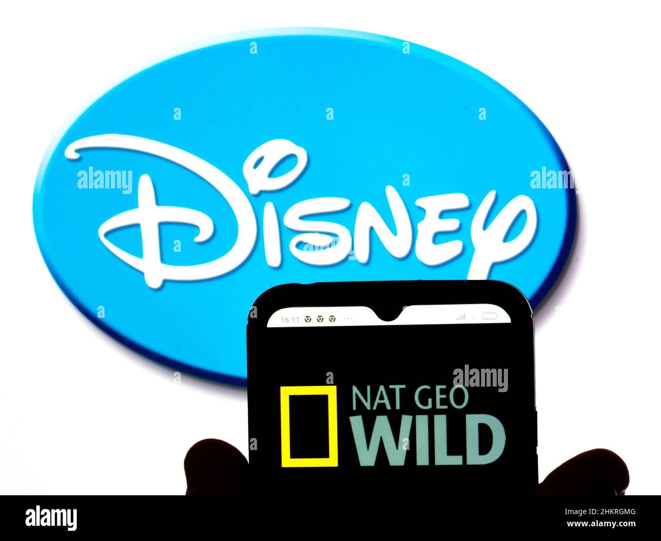 In this photo illustration, the Nat Geo Wild logo is displayed on a smartphone screen with a Disney logo in the background. Stock Photo