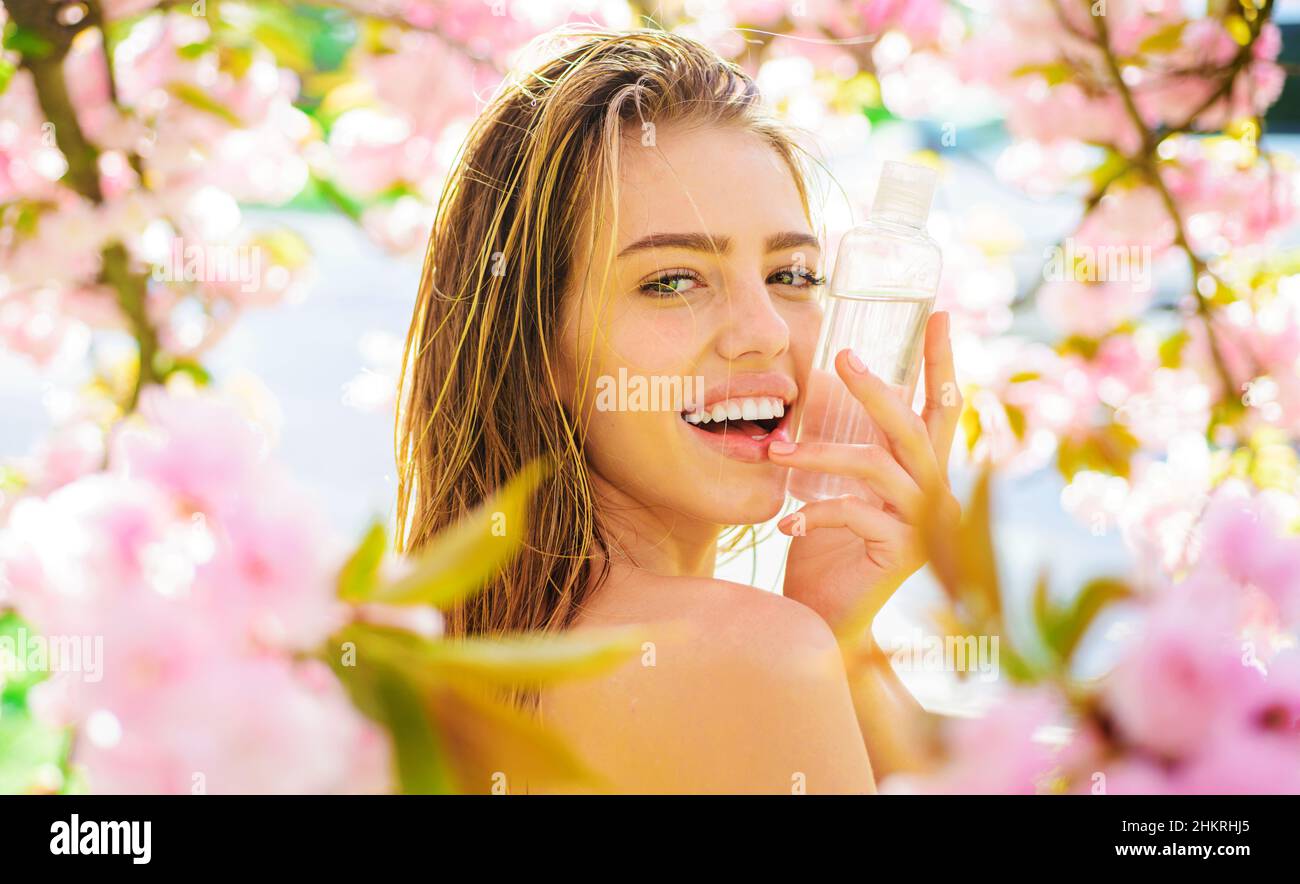 Happy girl with Cleansing water. Natural Cosmetics. Makeup remover. Face tonic. Beauty treatments. Stock Photo