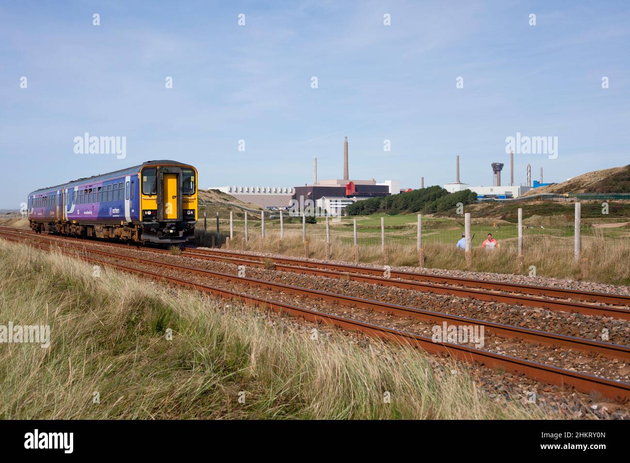 2 Northern rail class 153 sprinter trains 153301 + 153351 passing Sellafield nuclear reprocessing  plant on the Cumbrian coast railway line Stock Photo