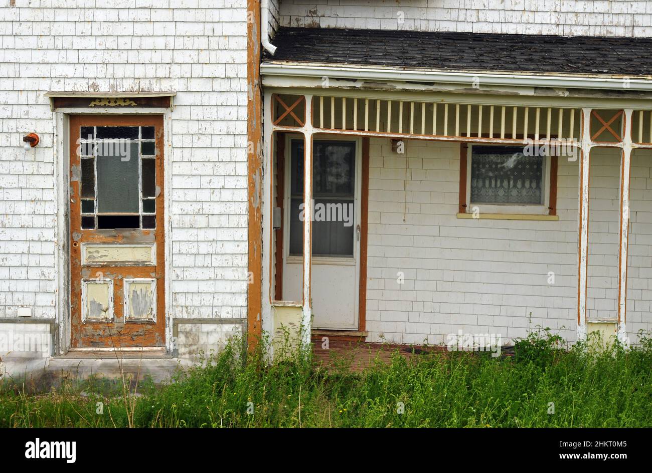 The doorway and porch of an old home faced with wood shingles in Hampton, Prince Edward Island. Stock Photo