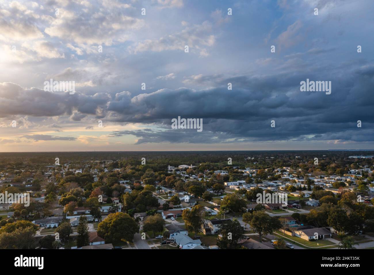 Aerial of an ominous approaching storm front facing west looking over tree tops and suburban community of Port Orange, Florida, USA. Stock Photo