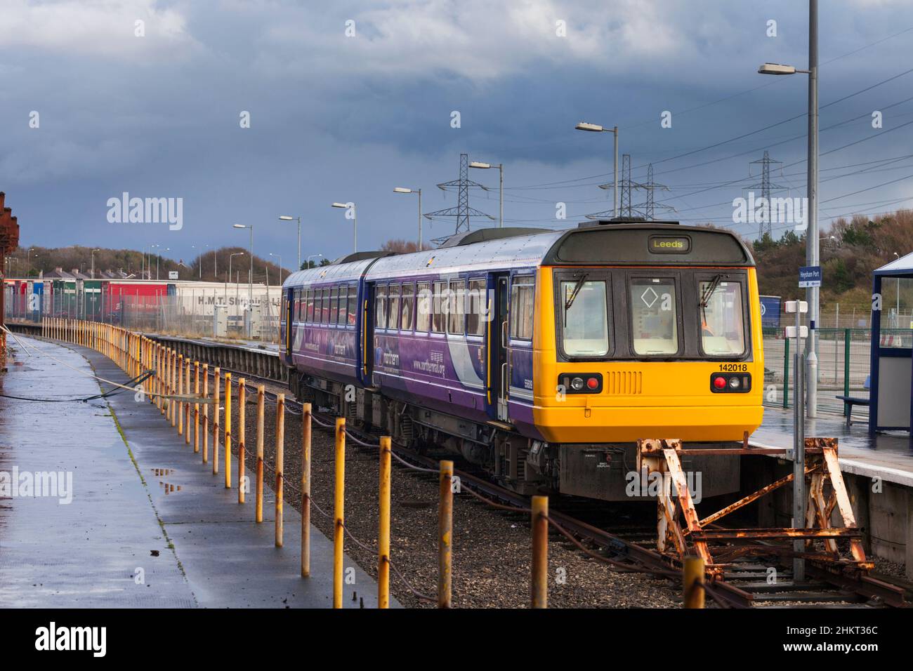 Northern Rail class 142 pacer train  at the semi derelict Heysham Port railway station with the daily boat train to connect with the Isle of Man Stock Photo