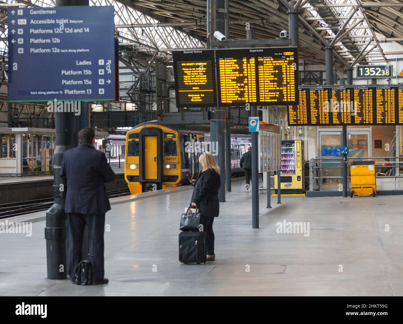 Northern rail class 158 train 158757 arriving at Leeds railway station with passenger information screens and waiting passengers Stock Photo