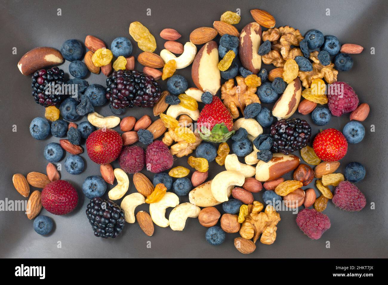 different berries and nuts on a plate. vitamin proteins and healthy