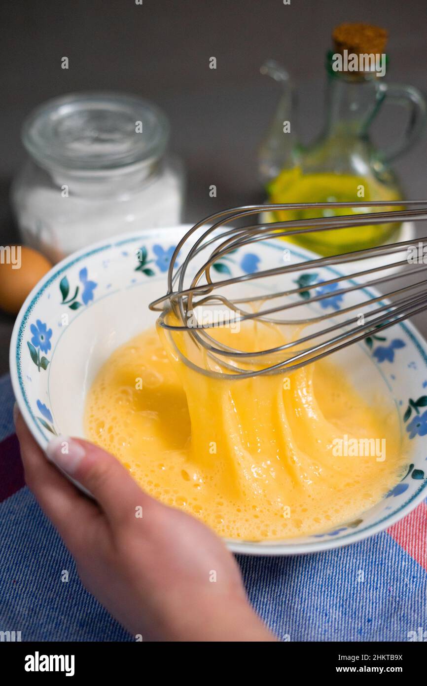 detail whisk eggs in a white bowl with a whisk Stock Photo