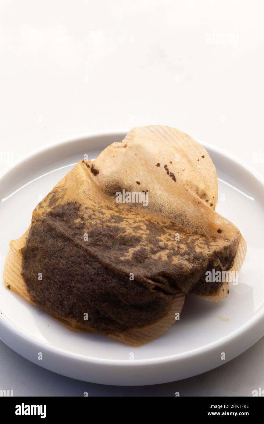 Used Teabag in a small dish on a kitchen counter Stock Photo