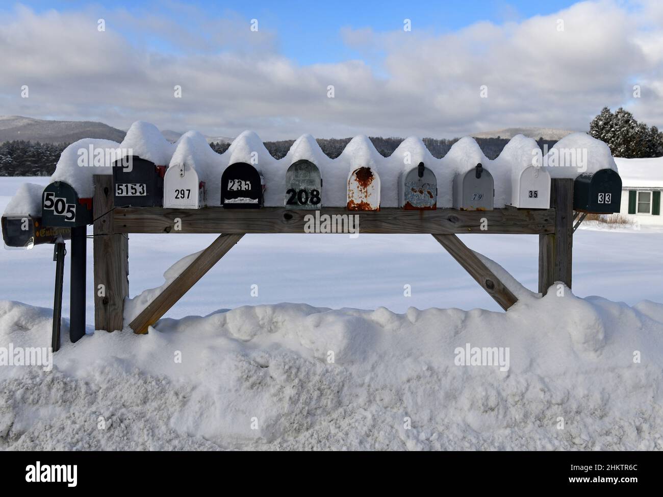 Mailboxes covered with fresh snow along rural road Stock Photo