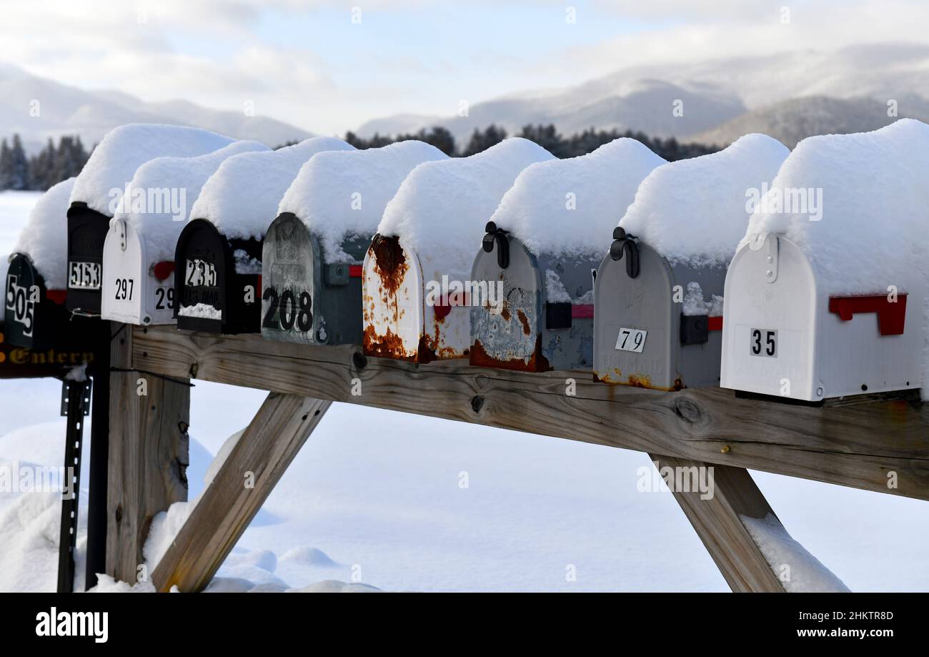 Mailboxes covered with fresh snow along rural road Stock Photo