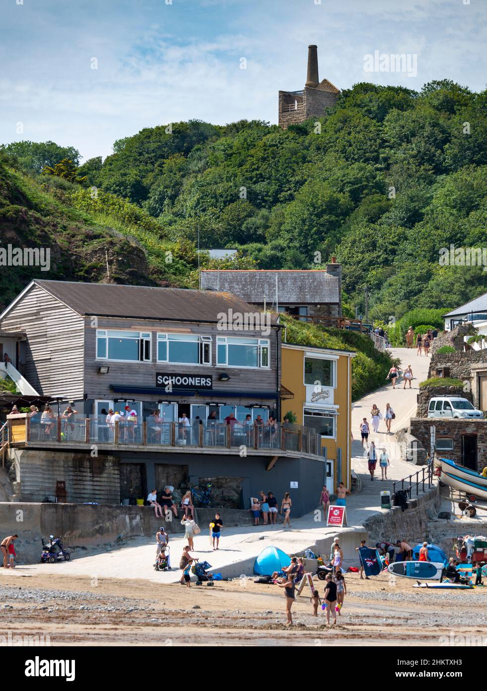 St.Agnes,Cornwall,England,UK-July 22: The relic of a disused tin mine overlooks the now family holiday bay of Trevaunance Cove during a hot mid summer Stock Photo