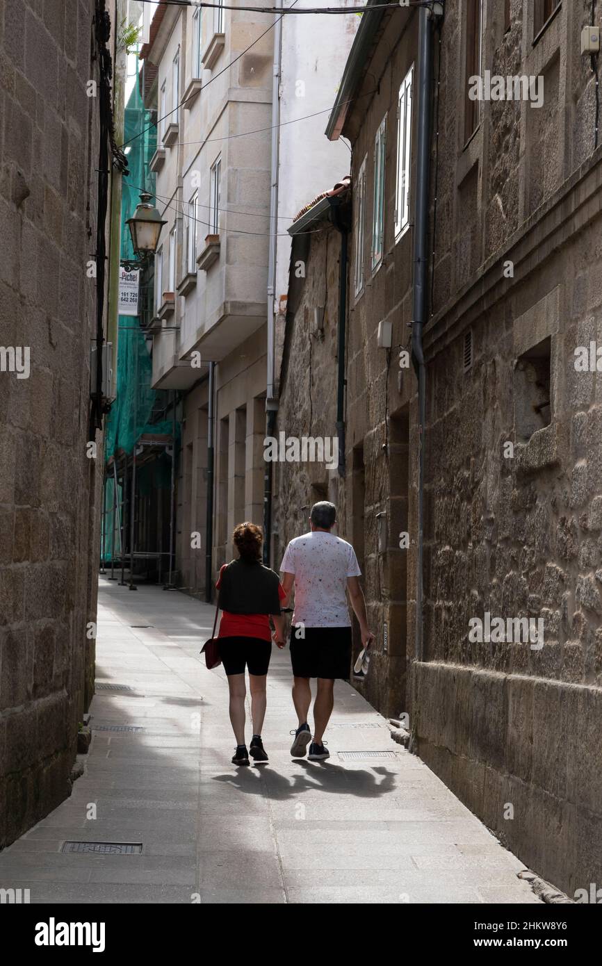 A couple walks along Rúa San Nicolás in the Centro Histórico of Pontevedra, Spain. Stock Photo