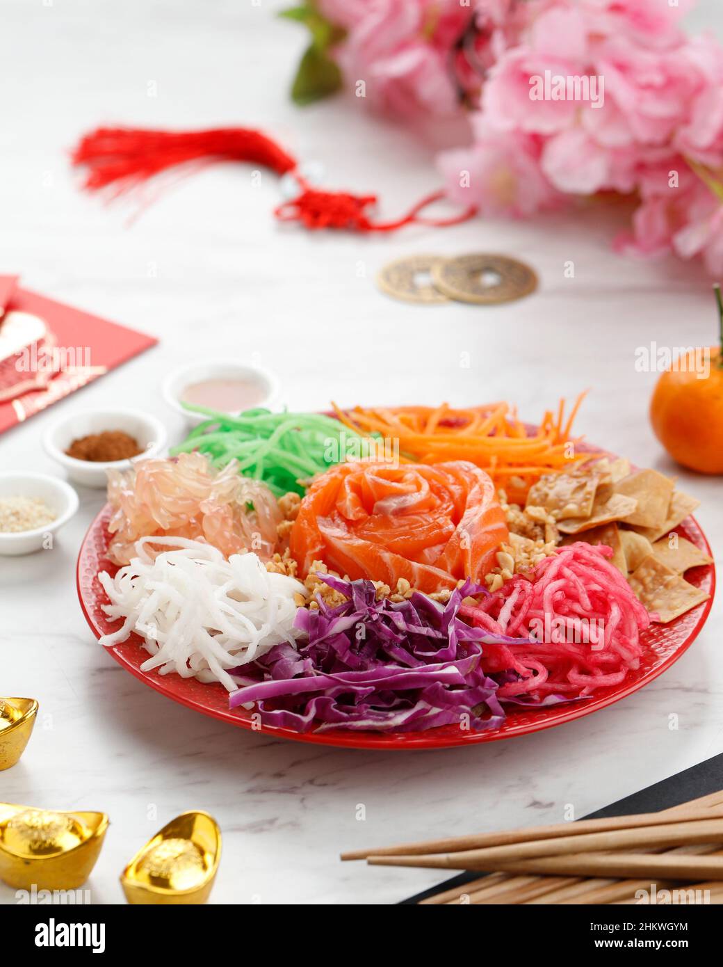Delicious and Colorful Display of Chinese Prosperity Cuisine, Yee Sang or Prosperity Toss. Carrot Strips, Purple Cabbage, Raw Salmon, Ground Peanuts, Stock Photo