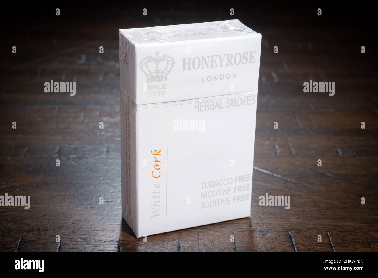 SAINT CLOUD, MINNESOTA - 5 FEBRUARY, 2022: A pack of Honeyrose Brand herbal cigarettes sits on a wooden table. Stock Photo