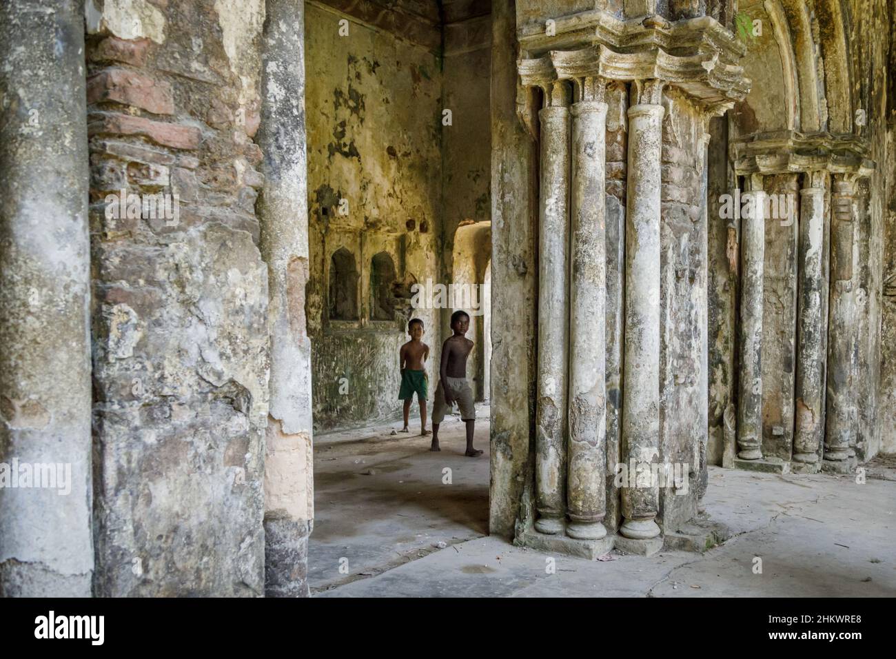 Two young boys playing in the ruins of the Teota Zamindar Palace in the Manikganj district. The palace, believed to be around 300 years old, had more than 50 rooms originally. Stock Photo