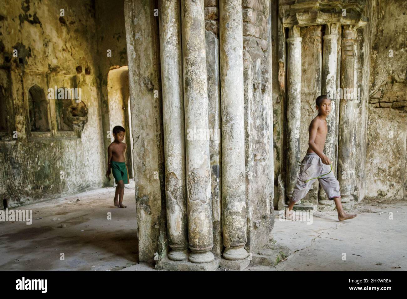 Two young boys playing in the ruins of the Teota Zamindar Palace in the Manikganj district. The palace, believed to be around 300 years old, had more than 50 rooms originally. Stock Photo