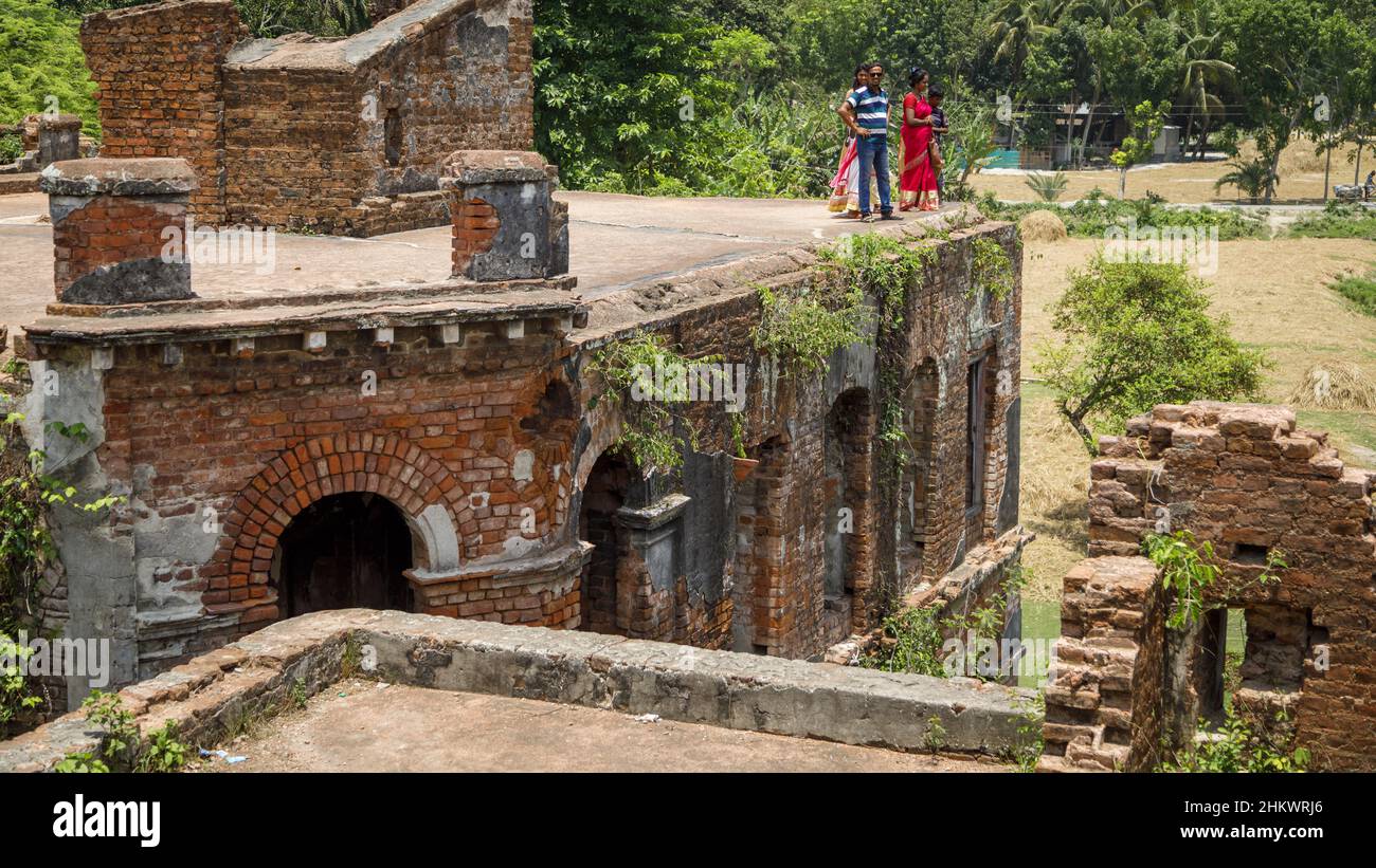 A young family on top of the ruins of the Teota Zamindar Palace in the Manikganj district. The palace, believed to be around 300 years old, had more than 50 rooms originally. Stock Photo
