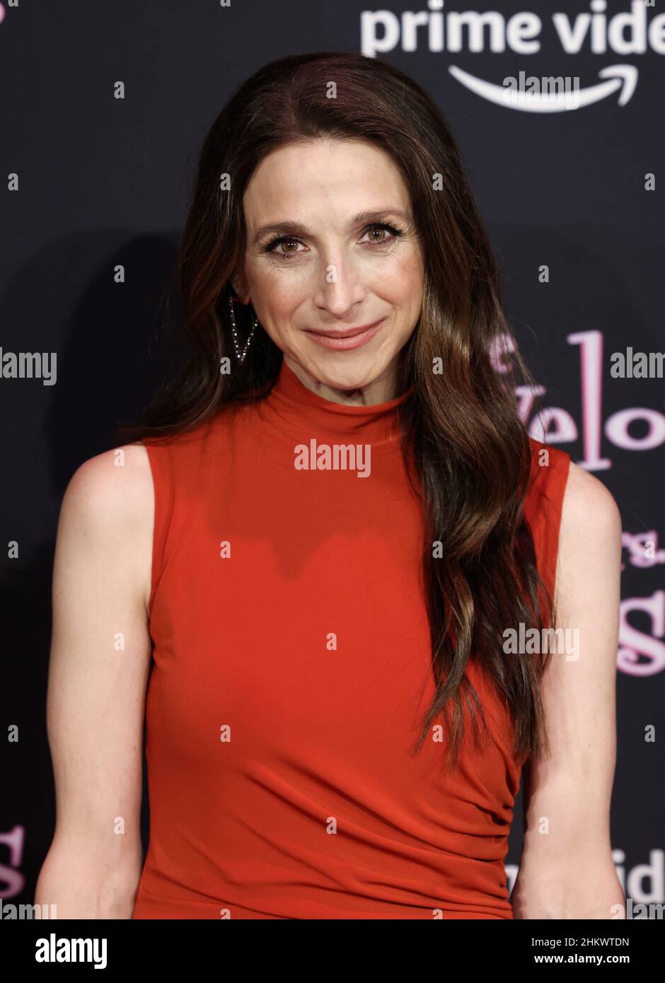 Marin Hinkle poses on a carpet before a Marvelous Mrs. Maisel 1960s ...