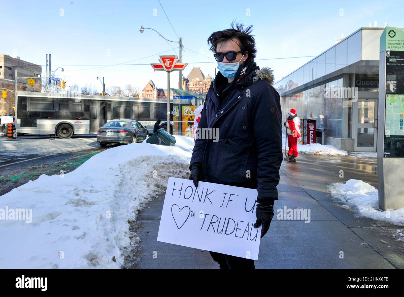 February 5, 2022. Toronto, Canada. Counter protester carries signage in support of health care workers during the Toronto's Freedom Convoy protest. Stock Photo