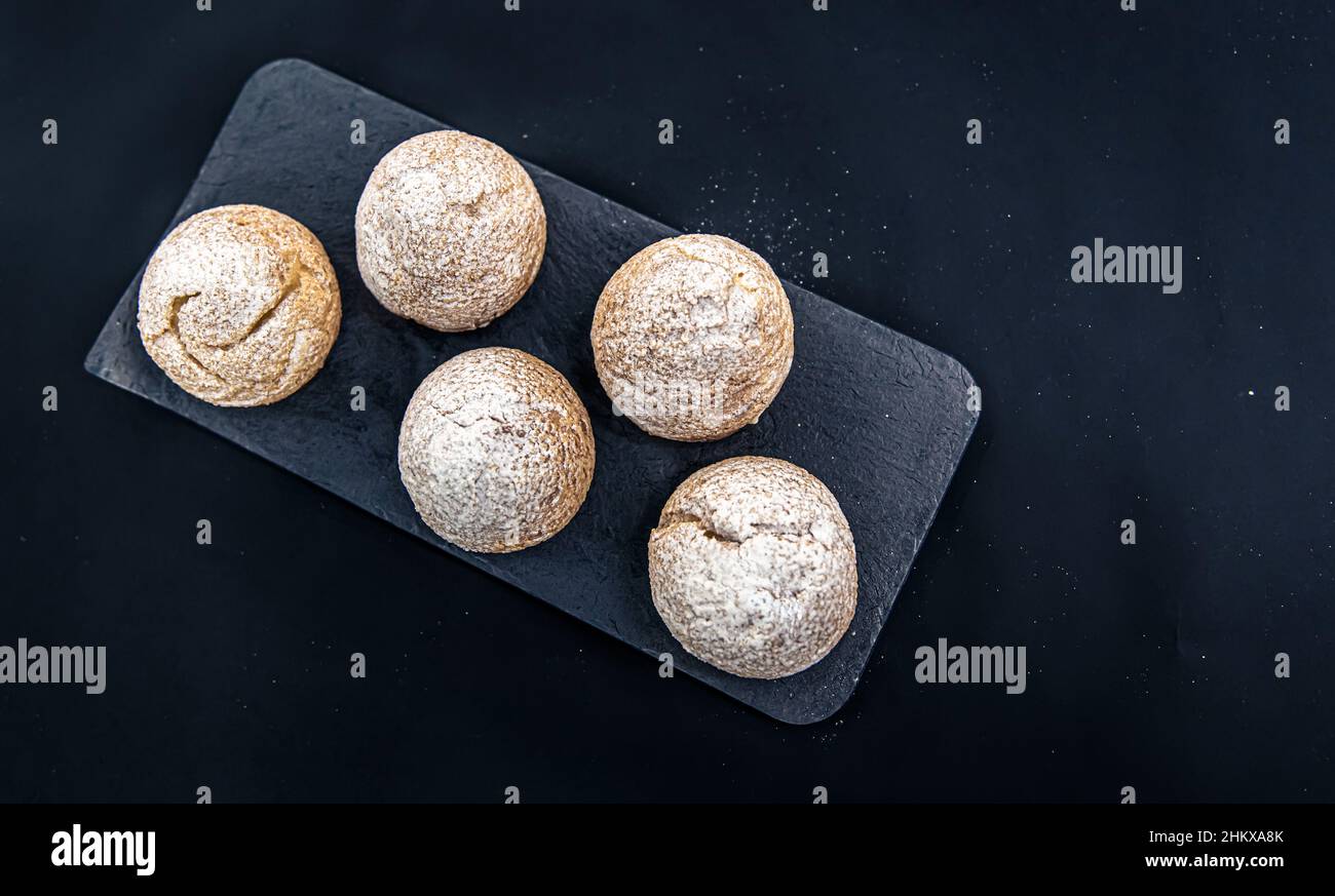 Appetizing Shu cakes on a black background. Stock Photo