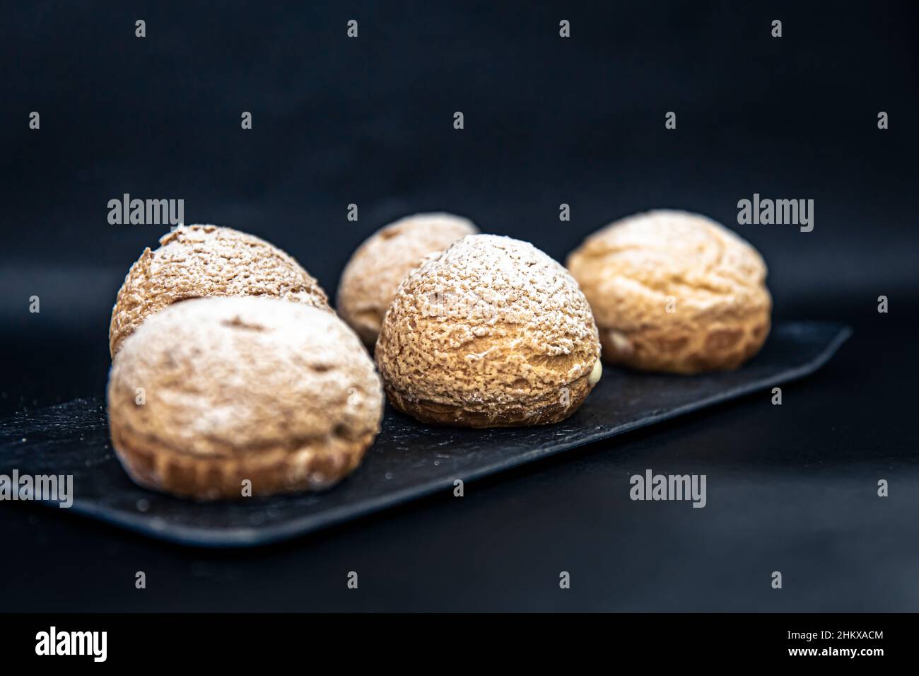 Appetizing Shu cakes on a black background. Stock Photo