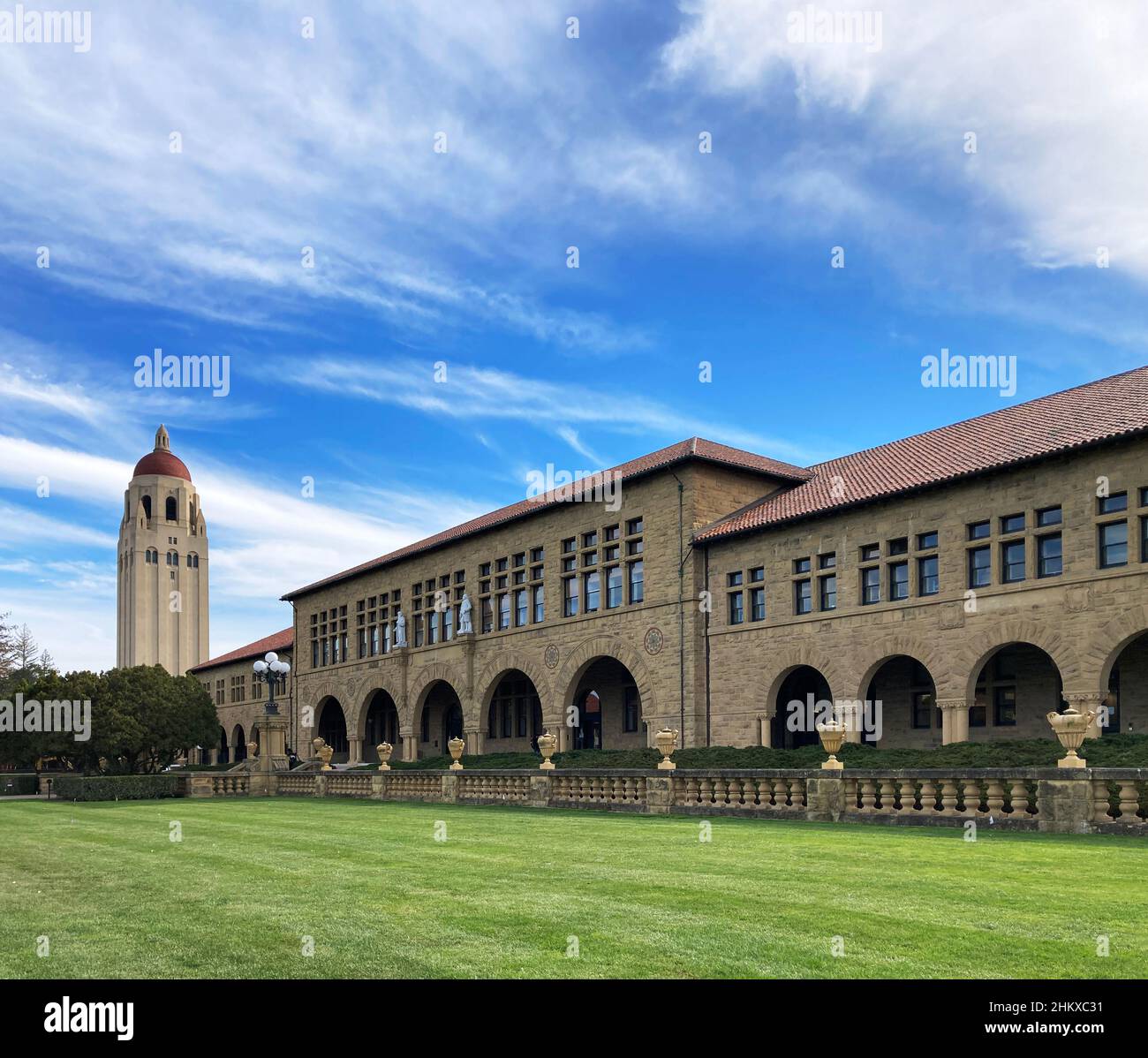 Hoover tower and Lane History Corner building on beautiful campus of Stanford University under blue sky - Palo Alto, California, USA - 2022 Stock Photo