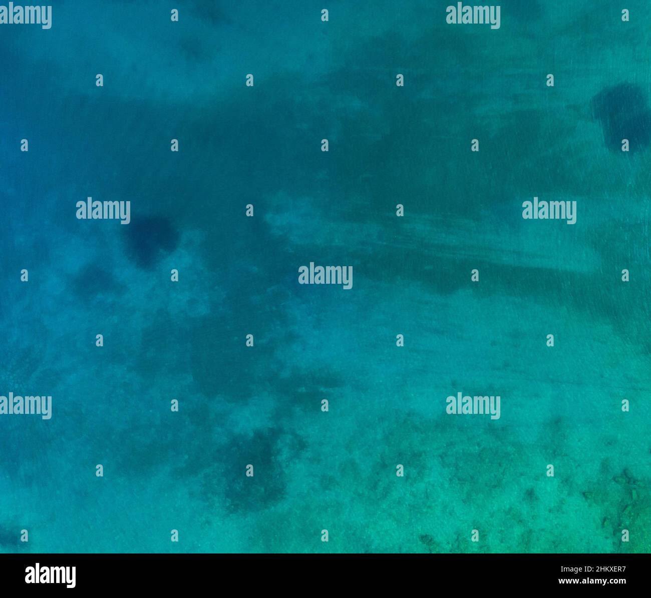 Aerial top view of sea waves hitting rocks on the beach with turquoise ...