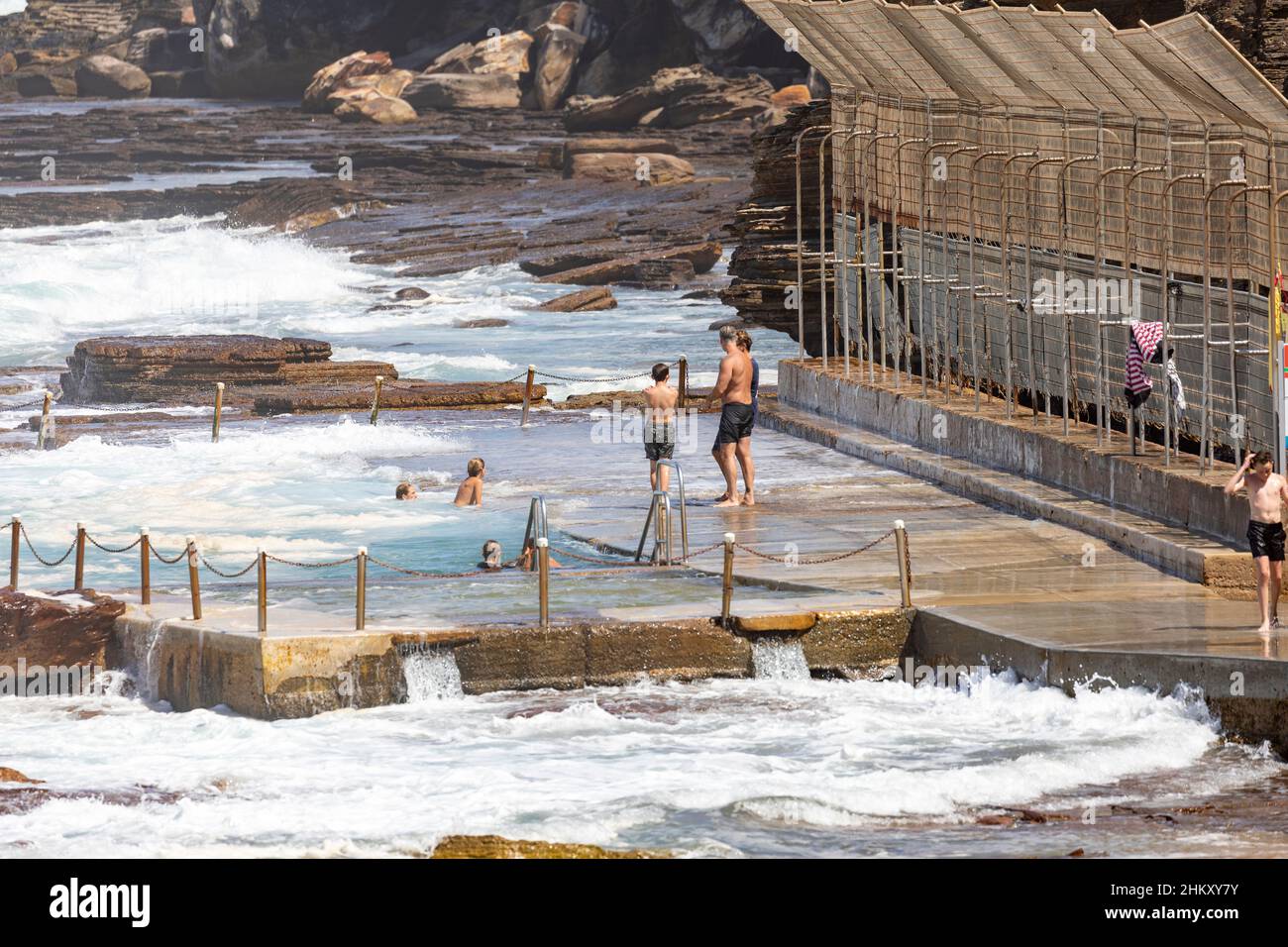 Avalon Beach rock pool swimming pool and teenage boys having fun in the water during summer,Sydney,NSW,Australia Stock Photo