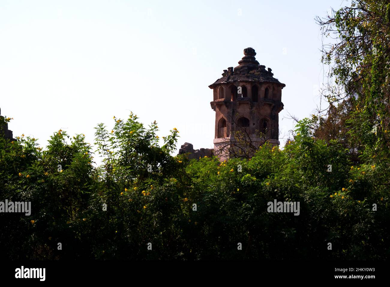 a long shot of Zanana enclosure tower isolated in green nature: Hampi, Karnataka, India-February 01.2022 Stock Photo