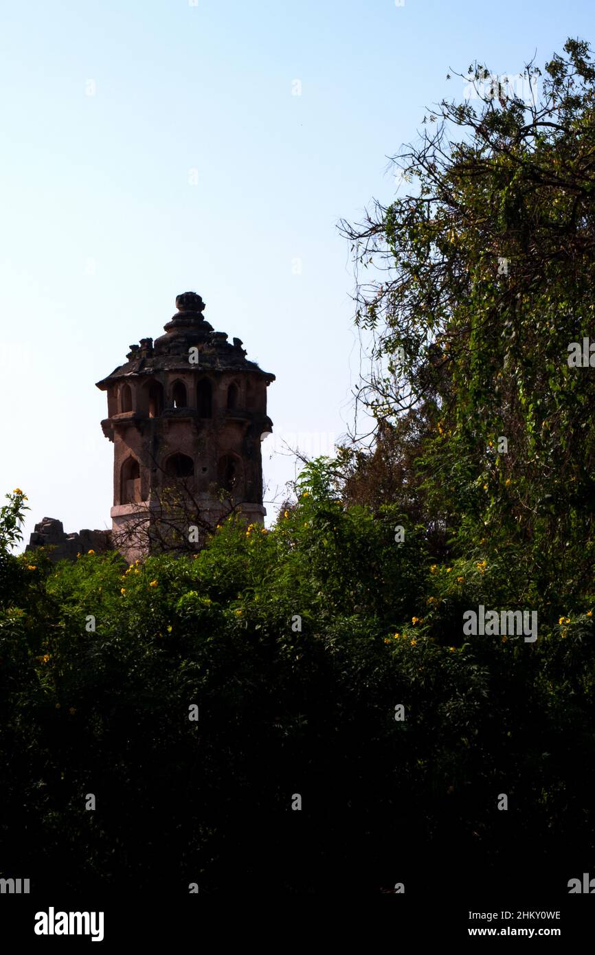 long shot of Zanana enclosure tower isolated in green nature vertical frame: Hampi, Karnataka, India-February 01.2022 Stock Photo