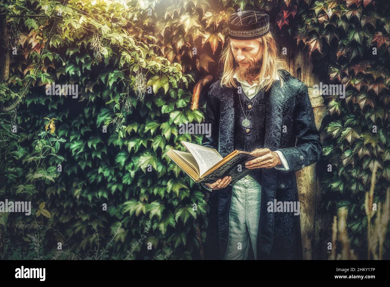 Alchemist in a beautiful ornamental dress in nature. Stock Photo