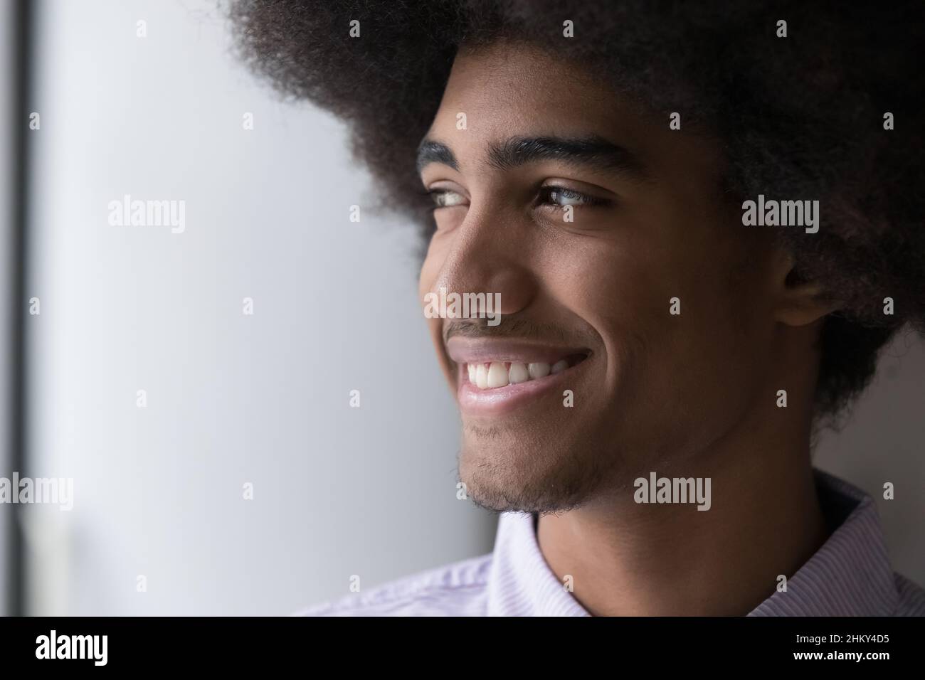 Cheerful handsome young Black guy with retro Afro hairdo Stock Photo