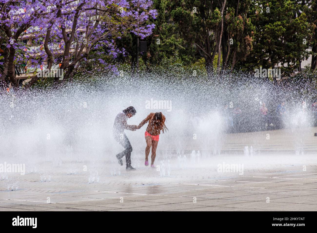 Young people having fun in a water fountain, Plaza de la República, Mexico City. North America Stock Photo