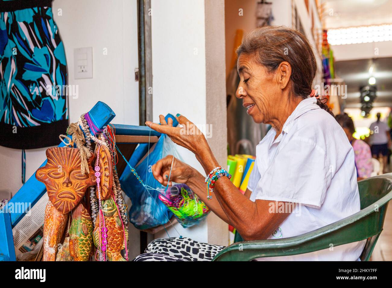 Craftswoman making bracelets Craft market. Manzanillo beach. Pacific Ocean. Colima. Mexico, North America Stock Photo