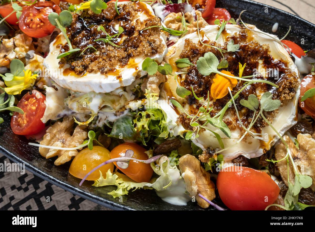 Salad with tomato, walnuts and goat cheese Stock Photo