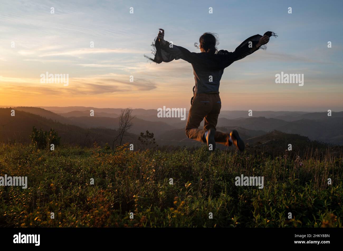 Young woman silhouette view on the top of a mountain with scenic ...