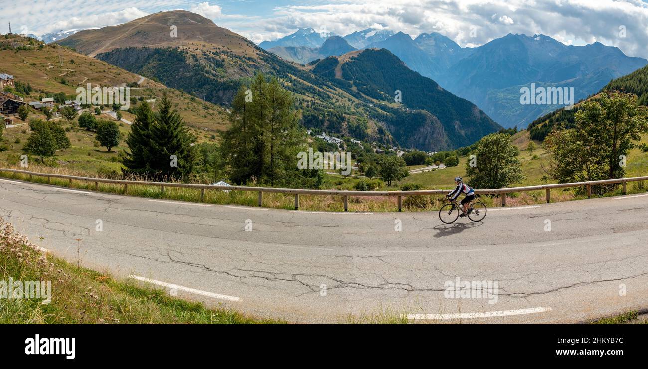 Mature female cyclist descending the classic climb of Alpe d'Huez
