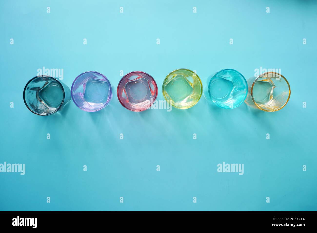 top view of empty drinking glasses on blue background  Stock Photo