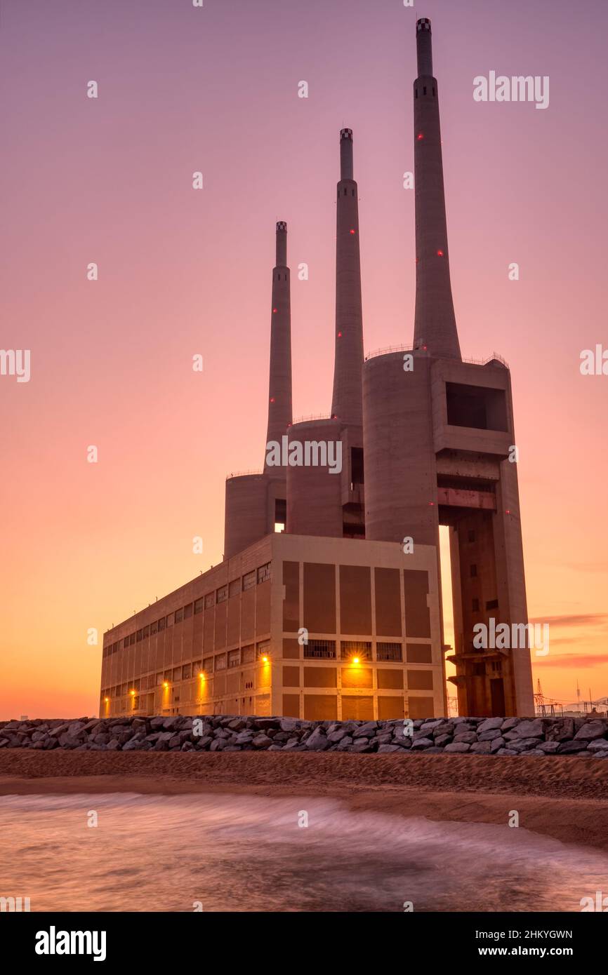 The disused thermal power station at Sand Adria near Barcelona at sunset Stock Photo