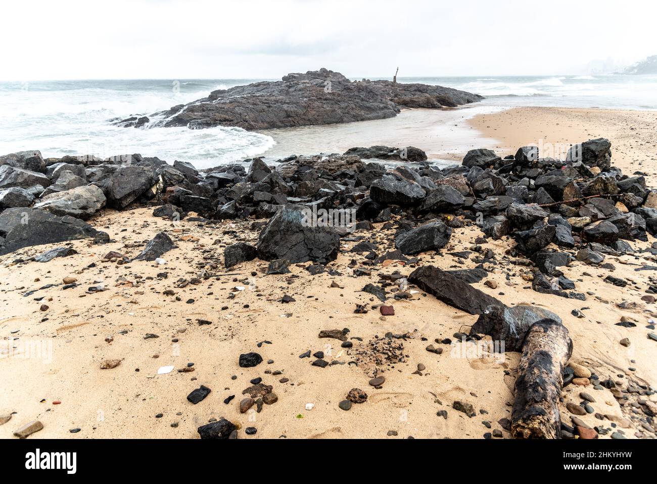 Rough sea crashing on the beach rocks Stock Photo - Alamy
